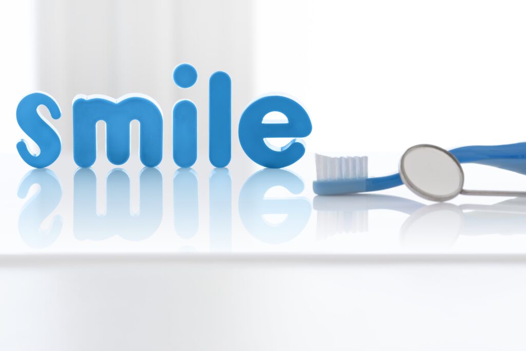 Home the word 'smile' in blue letters with toothbrush